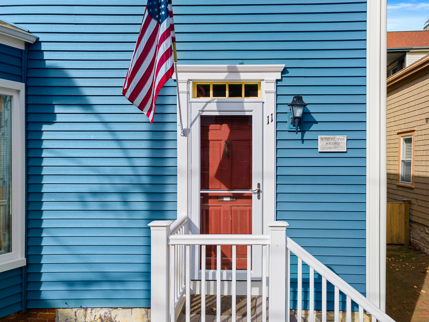 A beautiful home with blue siding on a sunny day.