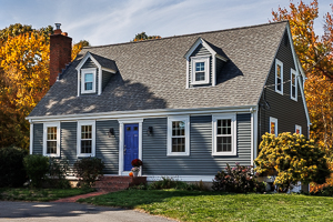 A beautiful home with blue siding on a sunny day.