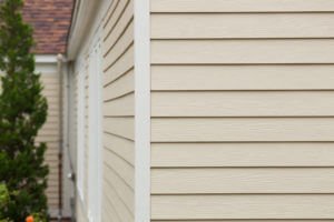 Cream Vinyl Siding Installation on MA Home by Marshall Building & Remodeling