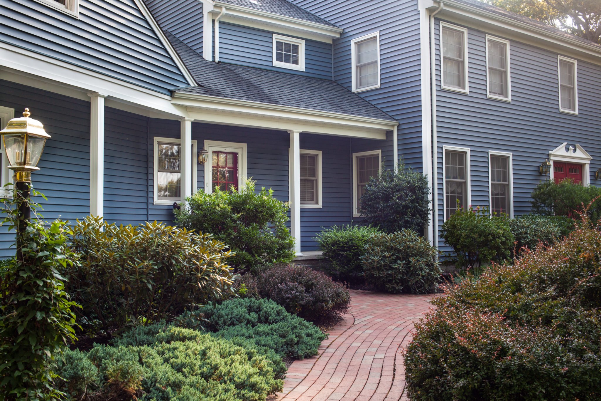 RI Renovated Colonial Home with Striking Blue Vinyl Siding by Roofers Marshall Building & Remodeling