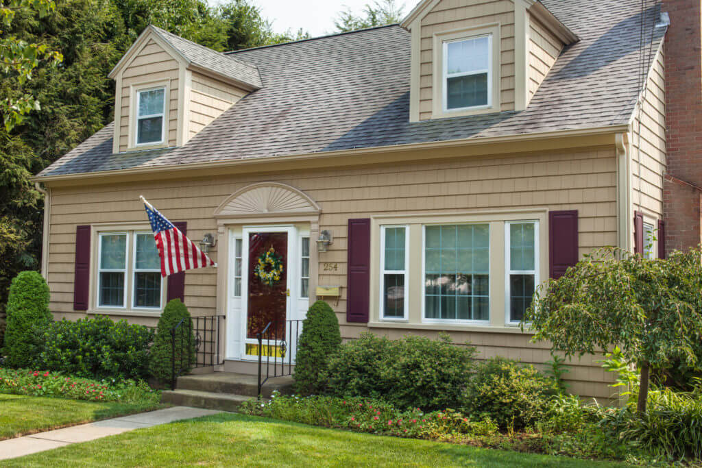 Cedar Impressions Siding in Suede Installed on RI Home with Wicker trim and Wineberry shutters