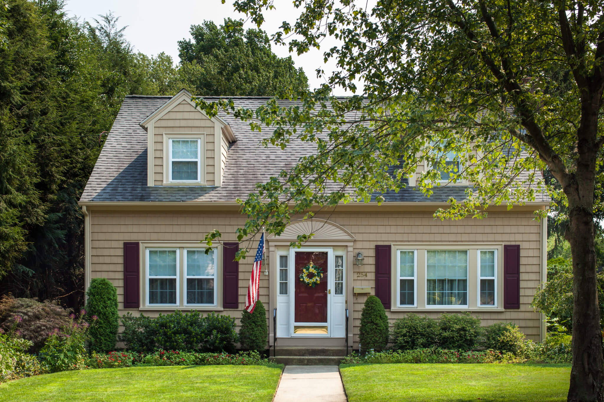 Cute RI Cape Home with New Cedar Impressions Siding Installed in Suede with Wicker Trim and Wineberry Shutters