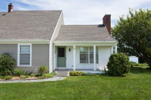 Natural Clay Cedar Impressions Vinyl Siding with White Vertical Vinyl Siding Installed on MA Home