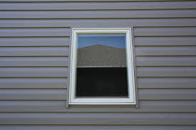 Gray Vinyl Siding and installed window without Trim Work in MA by Marshall Building and Remodeling