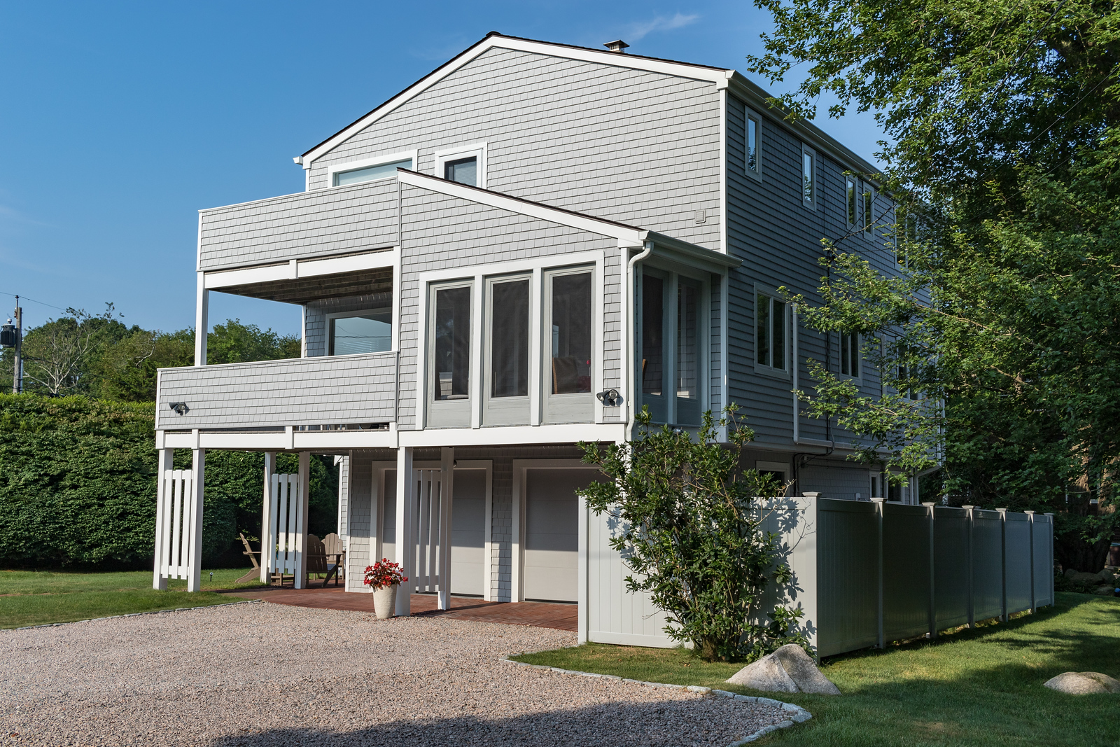 Three-story home with light gray siding