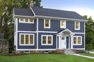 Two-story single-family home with blue siding and white trim