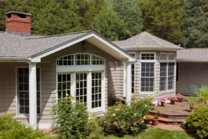 The front of a house with gray siding and roofing.