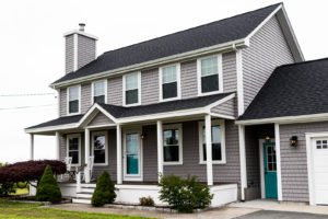 Two-story family home with grey vinyl siding and white trim