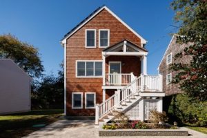 Copper colored house in front of bright blue sky