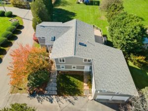 Aerial view of a house with a gray roof