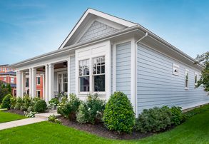 House with light blue vinyl siding and white trim